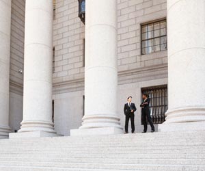Man and Woman Converse on the Steps of a Legal or Municipal Building